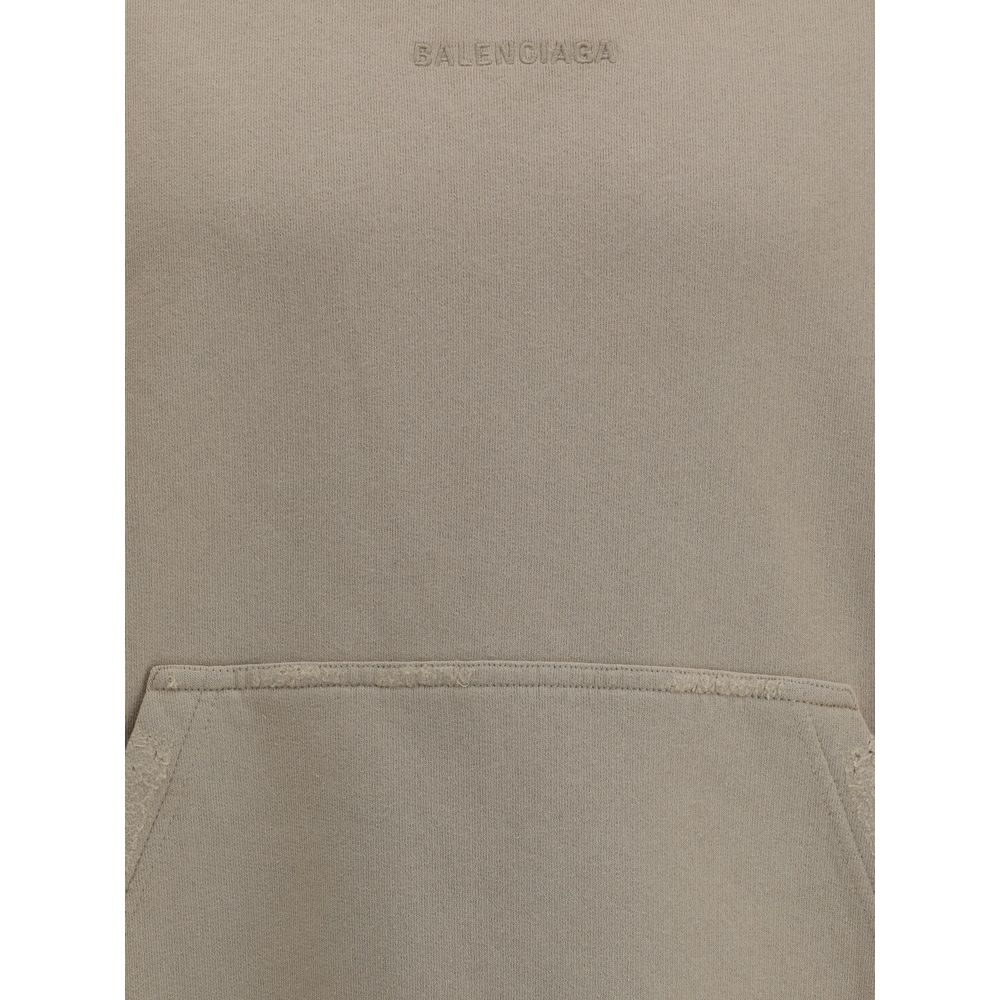 Beige Cotton SweatshirtCotton Hoodie by Balenciaga features a patch pouch pocket on the front and the iconic tone-on-tone embroidered monogram, lending a touch of understated sophistication. Ribbed cuffs and hem ensure a snug and comfortable fit. The vint