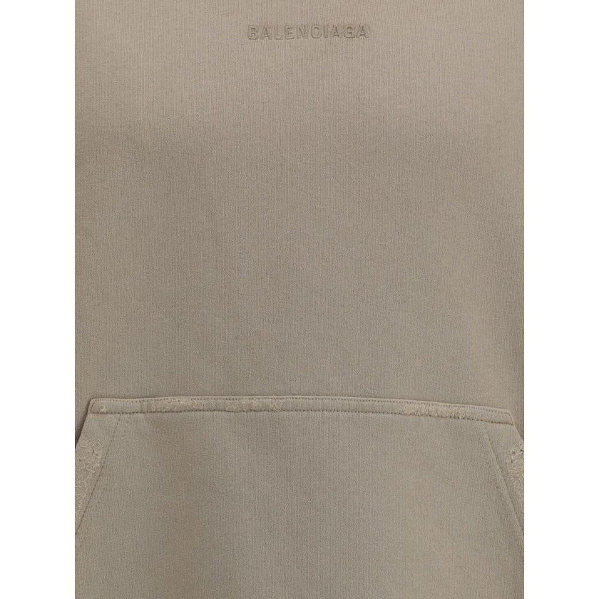 Beige Cotton SweatshirtCotton Hoodie by Balenciaga features a patch pouch pocket on the front and the iconic tone-on-tone embroidered monogram, lending a touch of understated sophistication. Ribbed cuffs and hem ensure a snug and comfortable fit. The vint