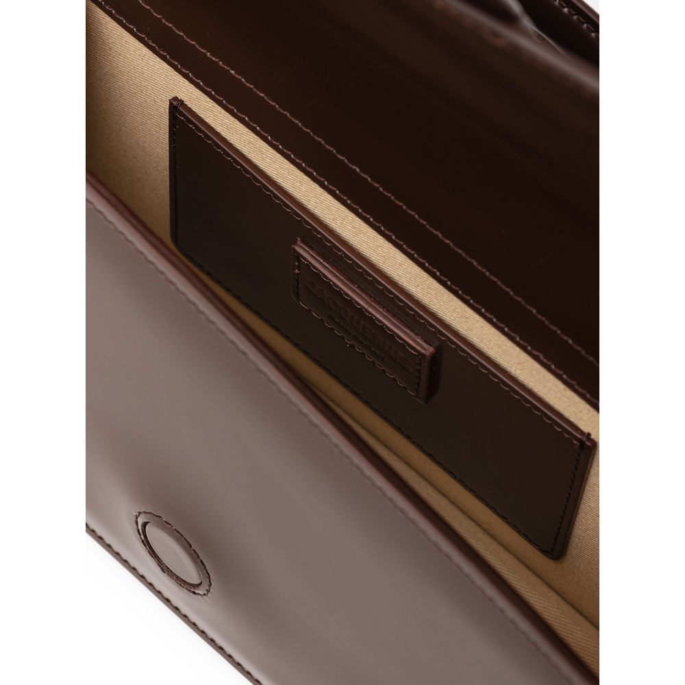 Brown Leather Le Grand Bambino HandbagJACQUEMUS Gorgeous brand new, 100% Authentic Jacquemus Le Grand Bambino light brown Bag. Model: 233BA007-3128 Color: Midnight Brown with Gold Hardware Material: Leather – Adjustable shoulder strap – Small handle – Rem