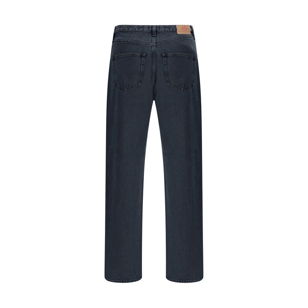Black Cotton Straight-Leg JeansCotton Jeans by Prada, made in the classic 5-pocket model with front button closure. The essential design is enriched by an applied logo patch on the back, a distinctive detail that recalls the brand’s iconic aesthetic. Seas