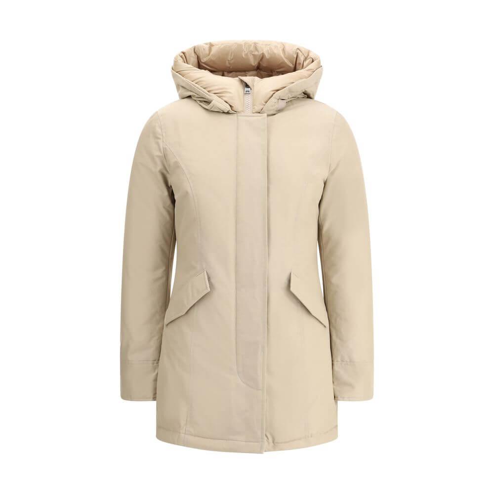 Beige Cotton ParkaArctic parka Jacket by Woolrich is made of durable Ramar Cloth fabric, treated with Teflon coating to provide protection from water and wind. Featuring a front zipper and concealed button closure, it has a protective hood, Velcro closure