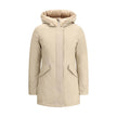 Beige Cotton ParkaArctic parka Jacket by Woolrich is made of durable Ramar Cloth fabric, treated with Teflon coating to provide protection from water and wind. Featuring a front zipper and concealed button closure, it has a protective hood, Velcro closure