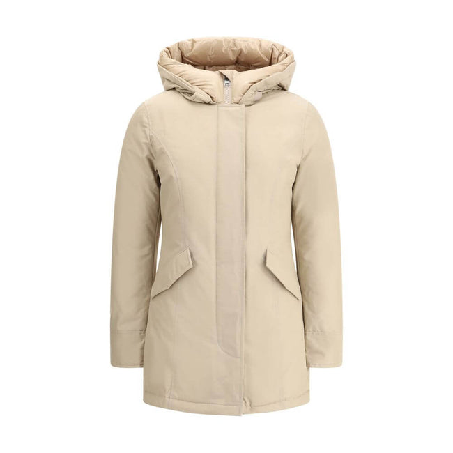 Beige Cotton ParkaArctic parka Jacket by Woolrich is made of durable Ramar Cloth fabric, treated with Teflon coating to provide protection from water and wind. Featuring a front zipper and concealed button closure, it has a protective hood, Velcro closure