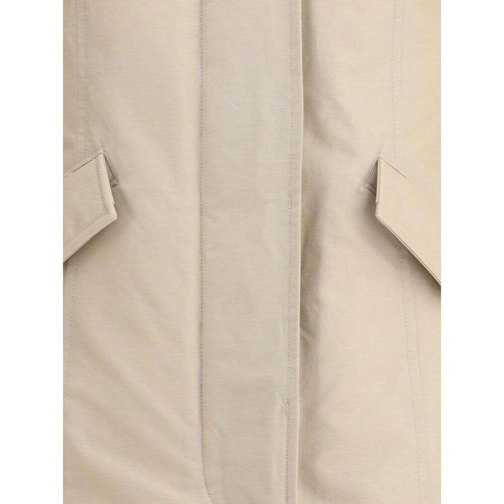 Beige Cotton ParkaArctic parka Jacket by Woolrich is made of durable Ramar Cloth fabric, treated with Teflon coating to provide protection from water and wind. Featuring a front zipper and concealed button closure, it has a protective hood, Velcro closure