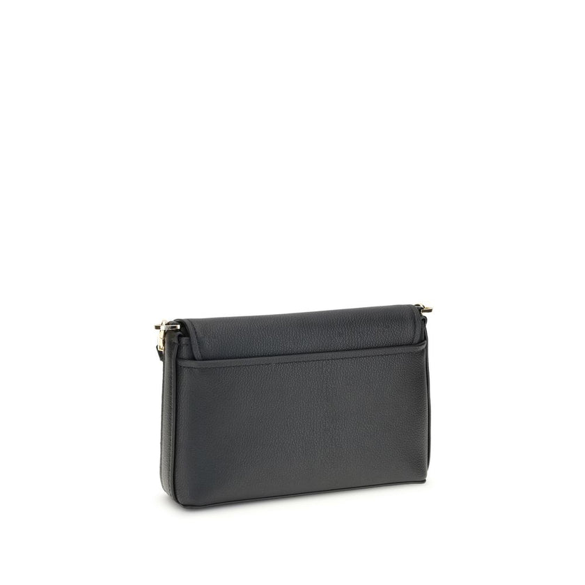 Small Nessa Shoulder BagThe small Nessa Shoulder Bag by Michael Kors combines practicality and style in a compact design. Equipped with a removable and adjustable shoulder strap, it features a flap and snap closure. The logo on the front adds a distinctiv