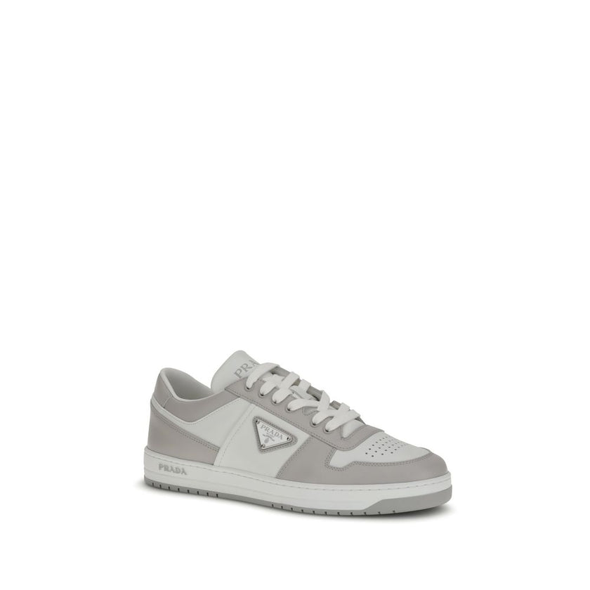 Downtown SneakersPrada’s Downtown Sneakers are made of smooth leather and feature an embossed logo on the back and the iconic logo triangle on the side. They feature a lace-up closure, perforated toe and printed logo on the padded tongue, as well as an in