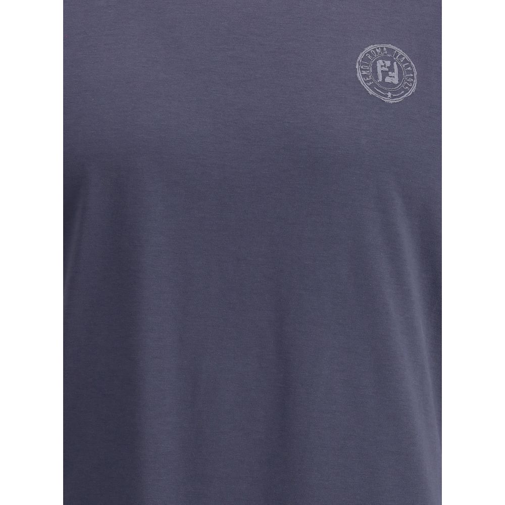 Blue Cotton T-ShirtFendi’s cotton T-Shirt is a casual garment with a strong character. Made from soft cotton, it features a ribbed crew neck and the iconic logo printed on the front for an essential yet instantly recognizable look. Season: AW25 Fit: Regul