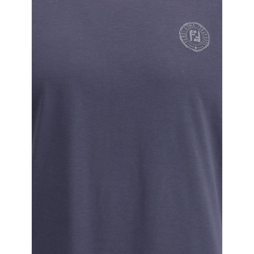 Blue Cotton T-ShirtFendi’s cotton T-Shirt is a casual garment with a strong character. Made from soft cotton, it features a ribbed crew neck and the iconic logo printed on the front for an essential yet instantly recognizable look. Season: AW25 Fit: Regul