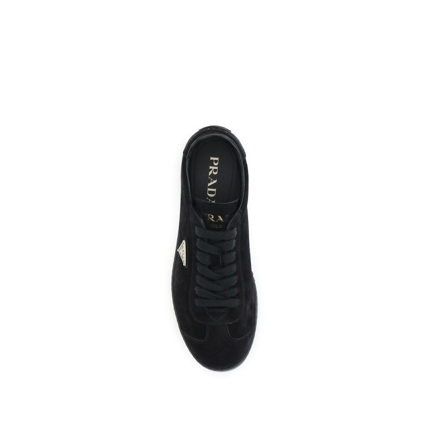 Black Calf Leather Bos Taurus Low Top SneakersPrada’s suede Sneakers combine contemporary style with everyday comfort. Featuring a flat rubber sole and round toe, they are distinguished by the iconic triangular side-applied plaque and tone-on-tone logo on