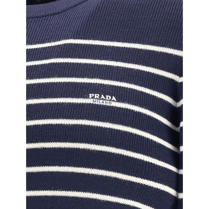 Blue Fleece Wool SweatshirtPrada’s virgin wool striped Sweater combines classicism and contemporary identity. Featuring a ribbed crew neck, it features a vibrant striped pattern and the iconic jacquard signature on the front, a distinctive detail that sig