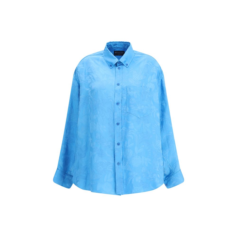 Blue Viscose Pattern ShirtBalenciaga’s Cocoon Shirt is made from a fine viscose-silk blend with a floral pattern, combining elegance and lightness. Featuring a cocoon silhouette with a rounded back, it has sloping shoulders, long sleeves and a hem that is