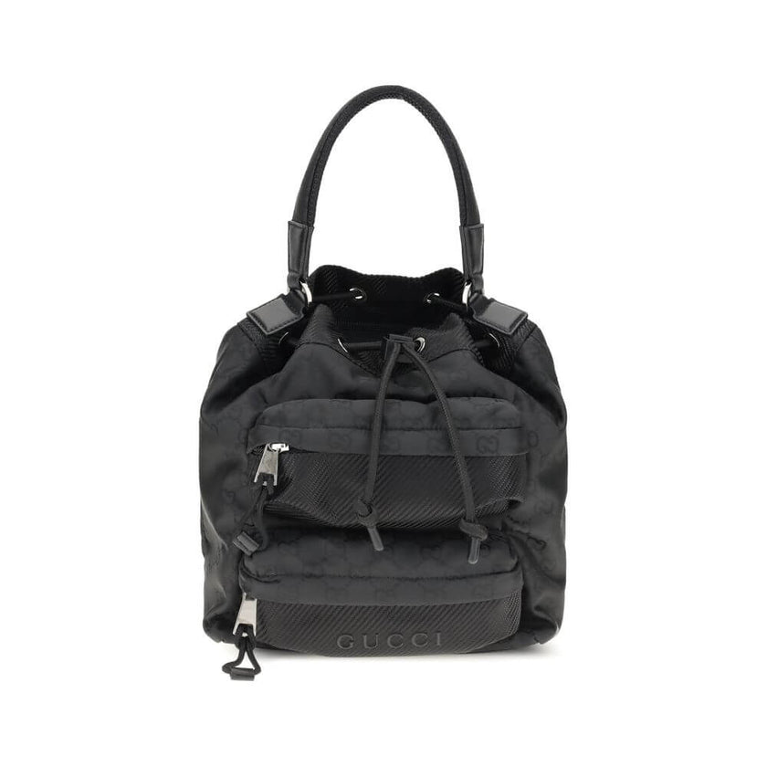 Black Polyamide Backet BagGucci’s Nylon Bucket Bag combines practicality and iconic style. Featuring a rigid handle and drawstring closure, it has two front zippered pockets for functional organization. The design is embellished with the iconic all-over G