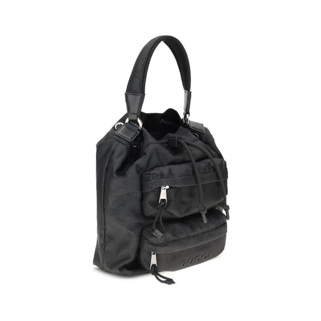 Black Polyamide Backet BagGucci’s Nylon Bucket Bag combines practicality and iconic style. Featuring a rigid handle and drawstring closure, it has two front zippered pockets for functional organization. The design is embellished with the iconic all-over G