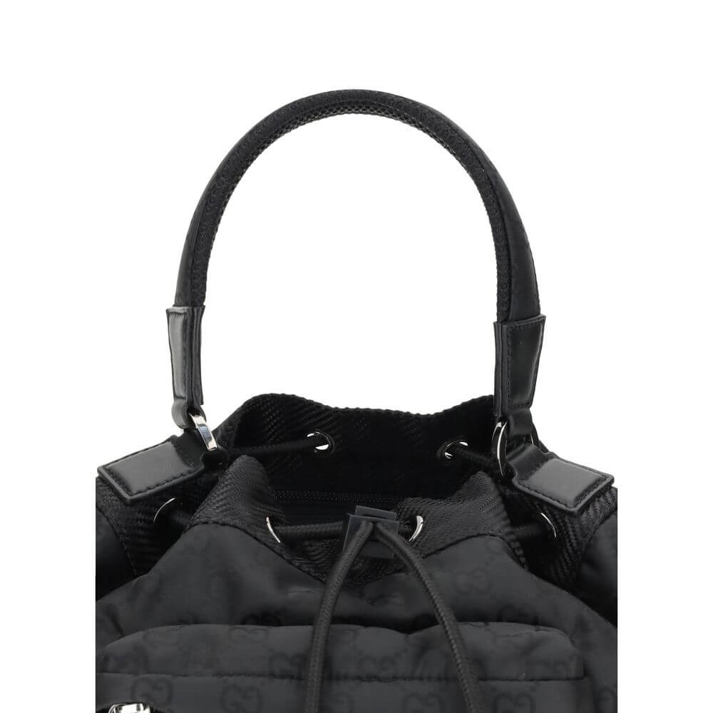 Black Polyamide Backet BagGucci’s Nylon Bucket Bag combines practicality and iconic style. Featuring a rigid handle and drawstring closure, it has two front zippered pockets for functional organization. The design is embellished with the iconic all-over G
