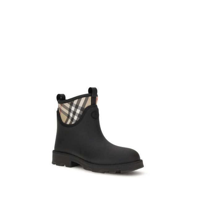 Black Rubber Ankle BootsBurberry’s Marsh Stamp Ankle Boots combine functionality with iconic style. Made of rubber, they are woven with the Burberry Check pattern in the classic sand color. The round toe and compact design make them ideal for rainy days,