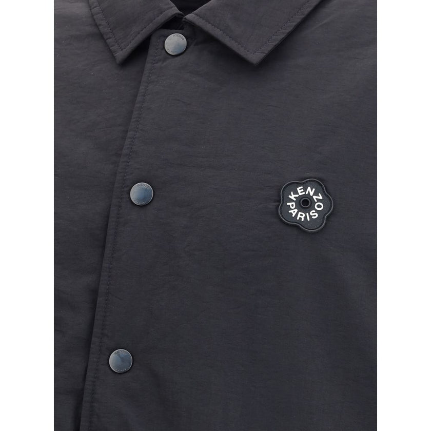 Black Nylon BomberKenzo’s Boke Flower 2.0 reversible Jacket combines functionality with iconic style. Made of matte polyester, it features a metal button closure and two side pockets. The reversible design offers two variations: one side with the Boke Flo