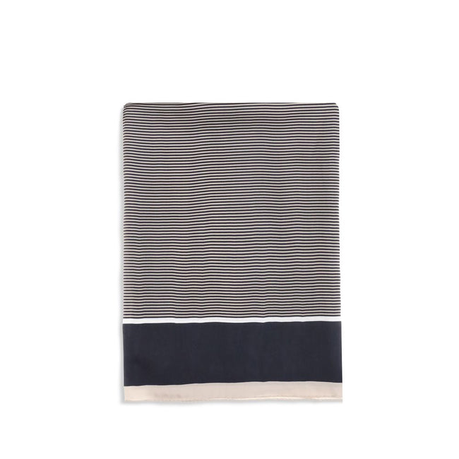 Cassandre striped StoleThe Saint Laurent Semi-Transparent Striped Stole is distinguished by the light elegance of the fabric and the essential design. The Cassandre signature stands out in the center, while the plain border and smooth trim complete the ac