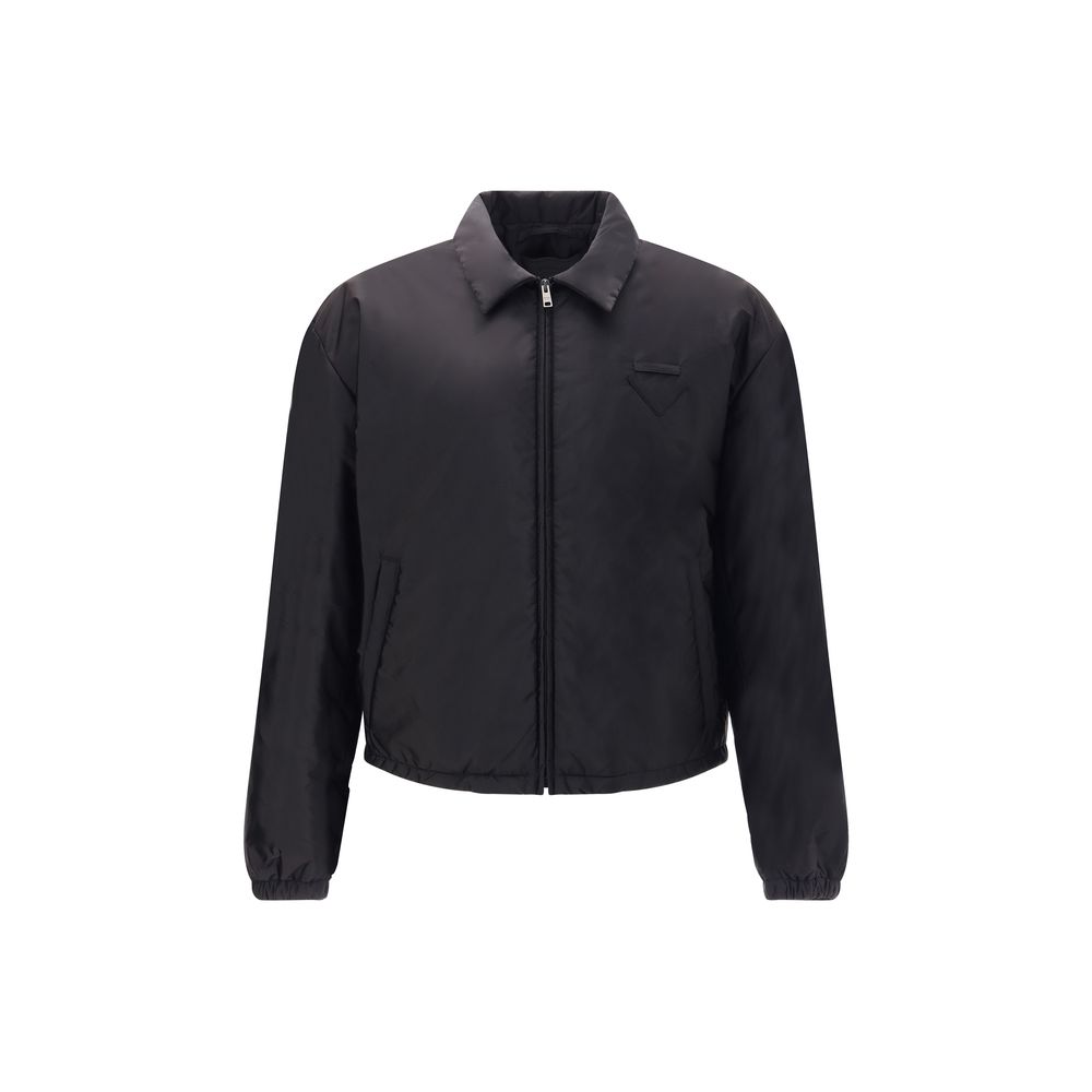 Re-Nylon bomber JacketThe Prada Re-Nylon Bomber Jacket combines sustainability with contemporary style. Featuring a classic collar and front zip, it features side welt pockets, elasticated cuffs and warm padding. The iconic triangle patch on the chest add