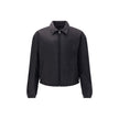Re-Nylon bomber JacketThe Prada Re-Nylon Bomber Jacket combines sustainability with contemporary style. Featuring a classic collar and front zip, it features side welt pockets, elasticated cuffs and warm padding. The iconic triangle patch on the chest add