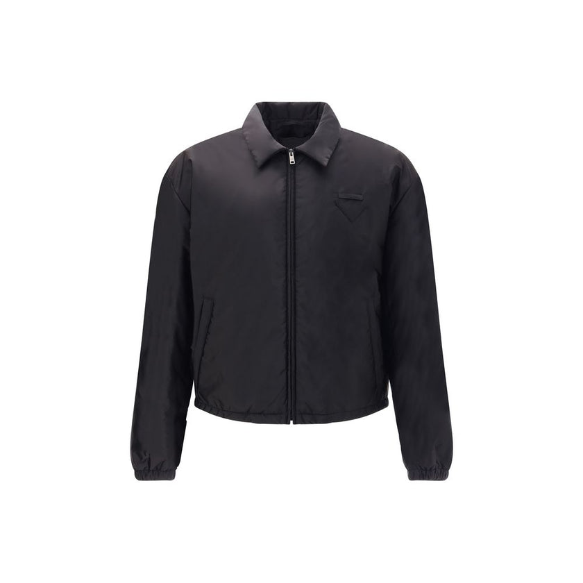 Re-Nylon bomber JacketThe Prada Re-Nylon Bomber Jacket combines sustainability with contemporary style. Featuring a classic collar and front zip, it features side welt pockets, elasticated cuffs and warm padding. The iconic triangle patch on the chest add
