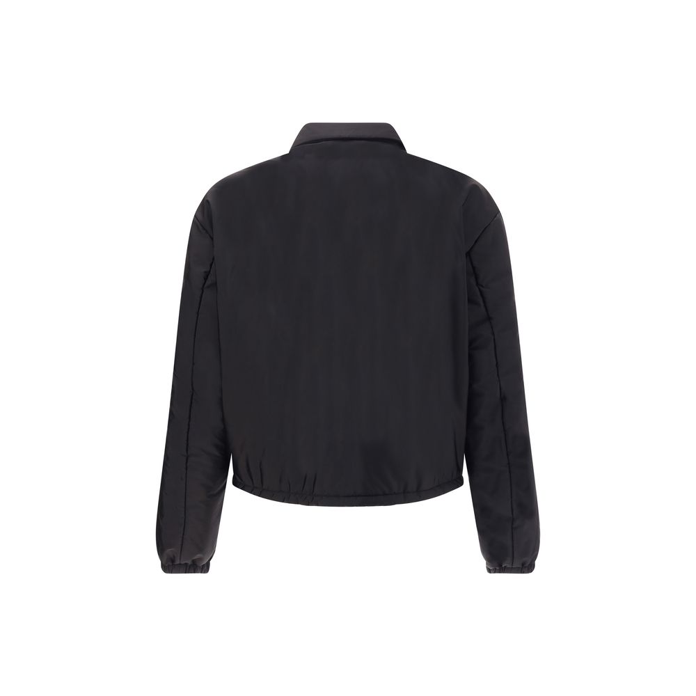 Re-Nylon bomber JacketThe Prada Re-Nylon Bomber Jacket combines sustainability with contemporary style. Featuring a classic collar and front zip, it features side welt pockets, elasticated cuffs and warm padding. The iconic triangle patch on the chest add