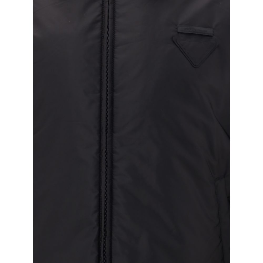 Re-Nylon bomber JacketThe Prada Re-Nylon Bomber Jacket combines sustainability with contemporary style. Featuring a classic collar and front zip, it features side welt pockets, elasticated cuffs and warm padding. The iconic triangle patch on the chest add
