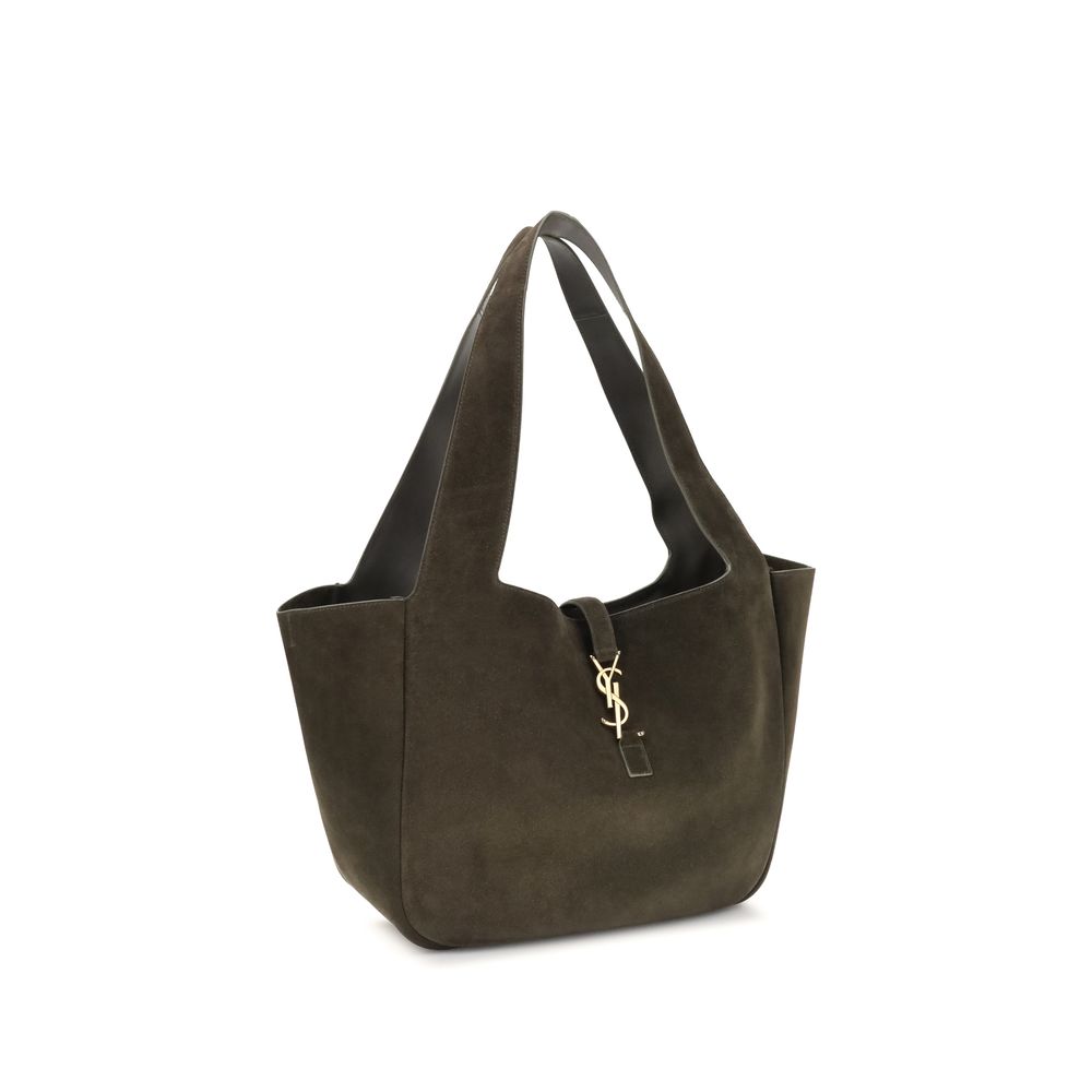 Green Calf Leather Bos Taurus Shoulder BagThe Le 5 à 7 Bea Tote Bag by Saint Laurent, made of suede leather, is an elegant versatile accessory with a refined design. The closure features a strap with a Cassandre logo plaque and a snap button, giving it a