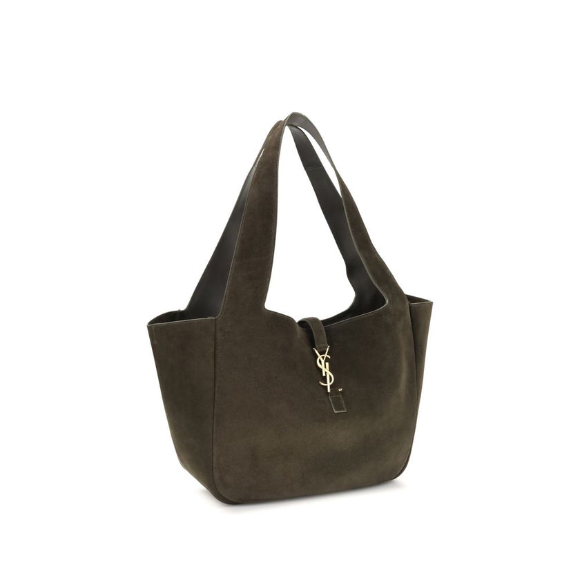 Green Calf Leather Bos Taurus Shoulder BagThe Le 5 à 7 Bea Tote Bag by Saint Laurent, made of suede leather, is an elegant versatile accessory with a refined design. The closure features a strap with a Cassandre logo plaque and a snap button, giving it a