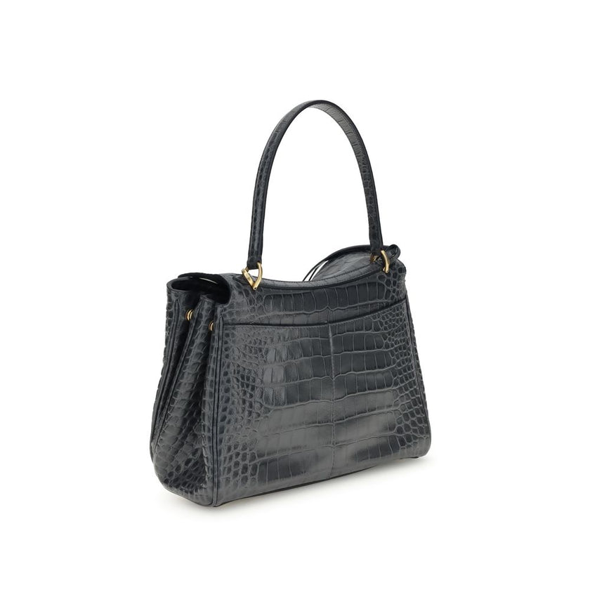 Black Calf Leather Bos Taurus Shoulder BagThe Rodeo Shoulder Bag in crocodile-print leather by Balenciaga features a top handle for a comfortable and elegant grip. The front closure is equipped with a flap and turn lock, adding a distinctive and functiona