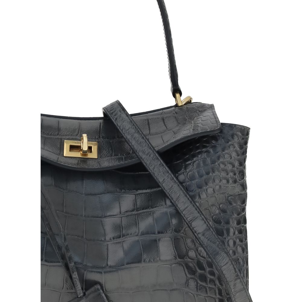 Black Calf Leather Bos Taurus Shoulder BagThe Rodeo Shoulder Bag in crocodile-print leather by Balenciaga features a top handle for a comfortable and elegant grip. The front closure is equipped with a flap and turn lock, adding a distinctive and functiona