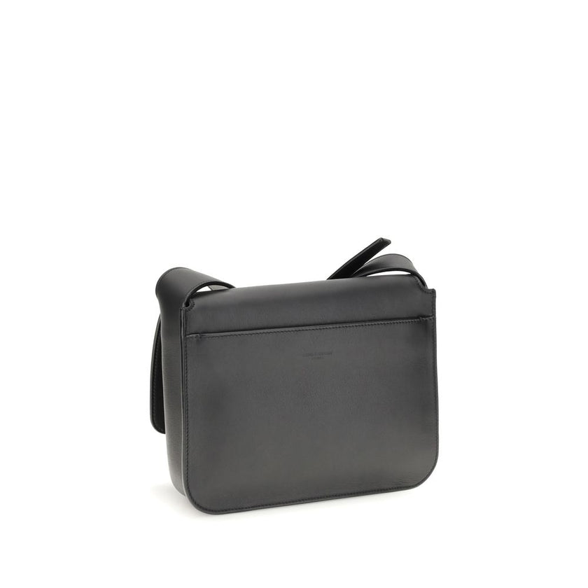 Black Calf Leather Bos Taurus Shoulder BagSaint Laurent’s small Messenger Shoulder Bag is crafted in tone-on-tone suede and features a front flap embossed with the SAINT LAURENT PARIS signature. Practical and functional, it features multiple pockets and a