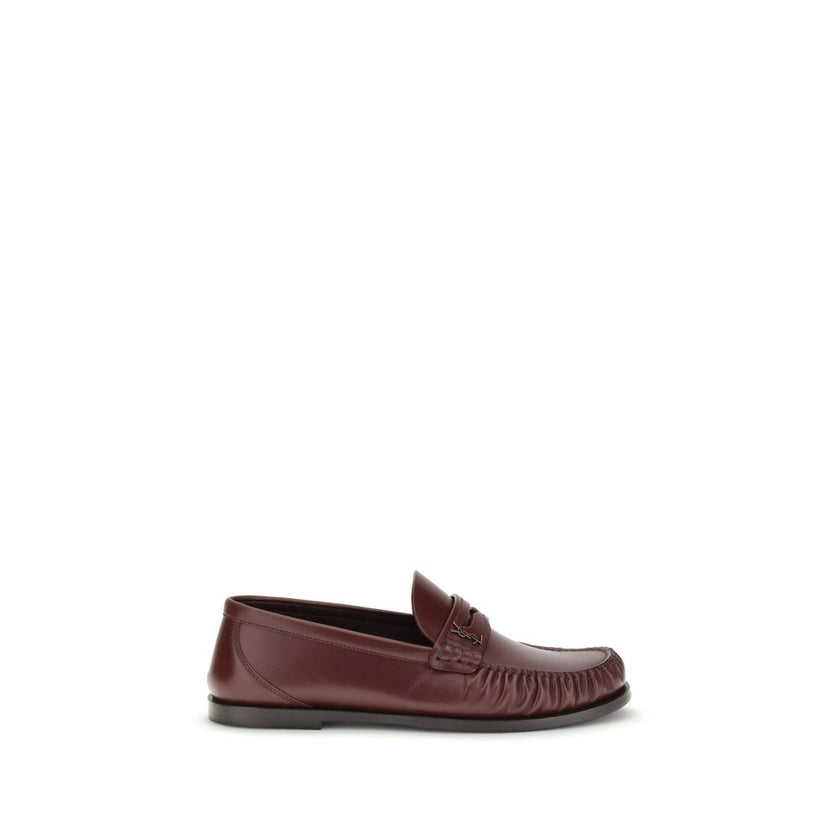 Brown Calf Leather Bos Taurus Slip-On LoafersSaint Laurent’s Laurent Loafers are a sleek, modern interpretation of the classic loafer. Featuring a hand-sewn square moc toe, they combine craftsmanship and contemporary design. The gold metal Cassandre decor