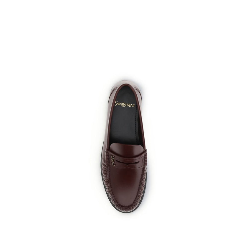 Brown Calf Leather Bos Taurus Slip-On LoafersSaint Laurent’s Laurent Loafers are a sleek, modern interpretation of the classic loafer. Featuring a hand-sewn square moc toe, they combine craftsmanship and contemporary design. The gold metal Cassandre decor
