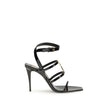 Black Calf Leather Bos Taurus Stiletto Heel SandalsSaint Laurent’s Cassandra Sandals embody the brand’s bold elegance. Crafted from patent leather, they feature a multi-strap design with a square toe and lacquered stiletto heel that slims the figure with