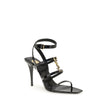 Black Calf Leather Bos Taurus Stiletto Heel SandalsSaint Laurent’s Cassandra Sandals embody the brand’s bold elegance. Crafted from patent leather, they feature a multi-strap design with a square toe and lacquered stiletto heel that slims the figure with