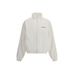 White Polyester Shell JacketBalenciaga’s Windbreaker Jacket is made of technical fabric and features contrasting logo embroidery on the chest and back. Featuring a high collar and concealed zipper closure, it offers two front zipper pockets. Gathered elas