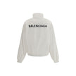 White Polyester Shell JacketBalenciaga’s Windbreaker Jacket is made of technical fabric and features contrasting logo embroidery on the chest and back. Featuring a high collar and concealed zipper closure, it offers two front zipper pockets. Gathered elas