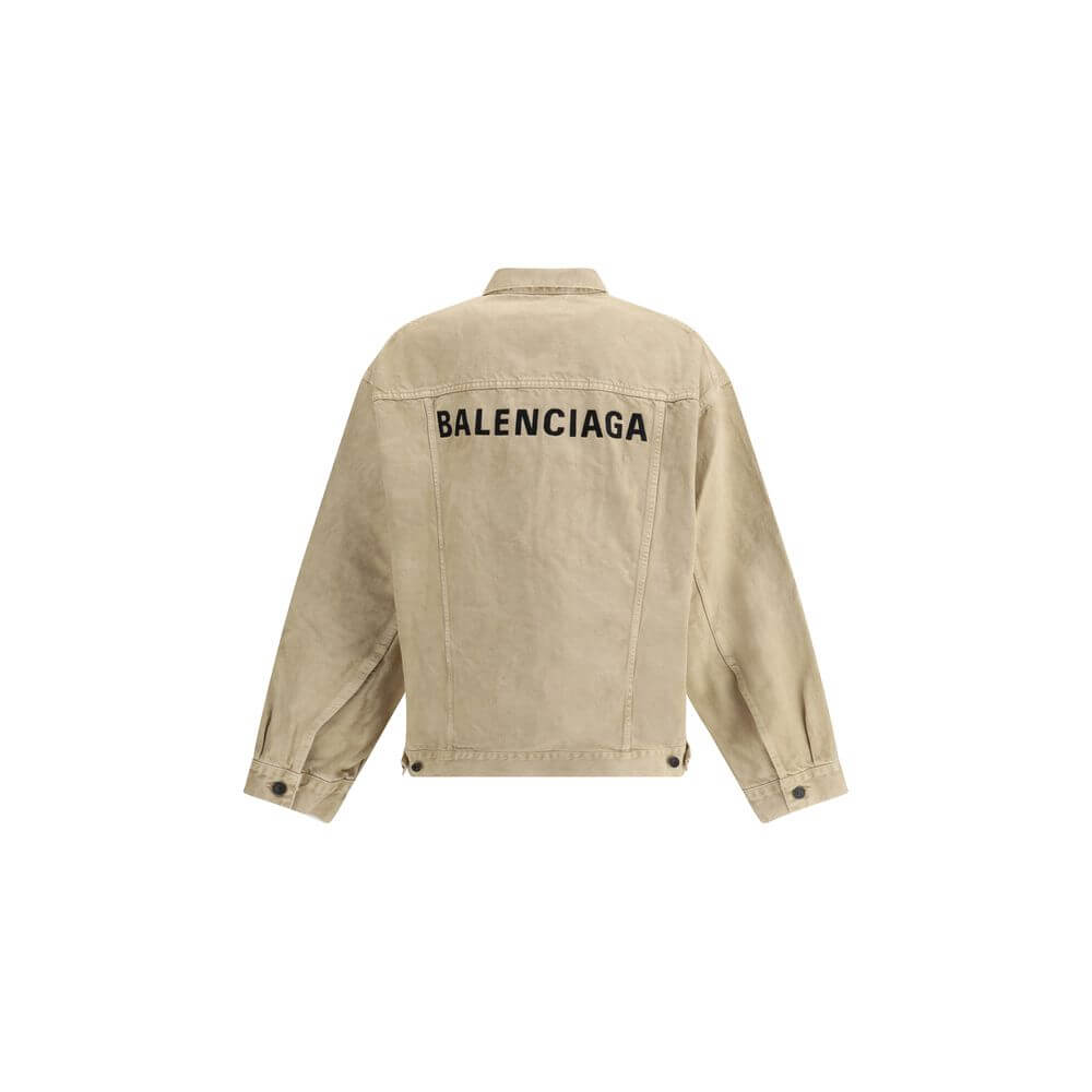 Beige Cotton Denim JacketThe oversized Denim Jacket by Balenciaga features a 7-button closure, front flap pockets and side slit pockets. Adjustable cuffs and waist with Balenciaga engraved metal buttons. The embroidered logo on the back elegantly signs th