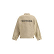 Beige Cotton Denim JacketThe oversized Denim Jacket by Balenciaga features a 7-button closure, front flap pockets and side slit pockets. Adjustable cuffs and waist with Balenciaga engraved metal buttons. The embroidered logo on the back elegantly signs th