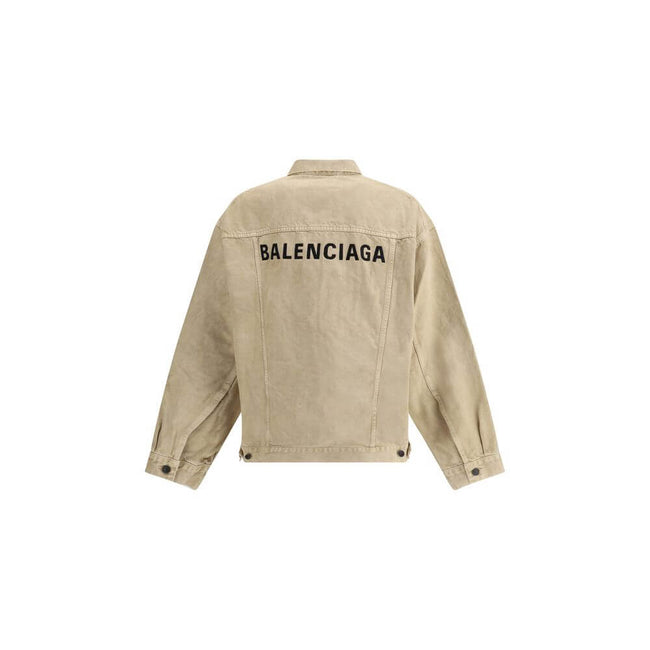 Beige Cotton Denim JacketThe oversized Denim Jacket by Balenciaga features a 7-button closure, front flap pockets and side slit pockets. Adjustable cuffs and waist with Balenciaga engraved metal buttons. The embroidered logo on the back elegantly signs th