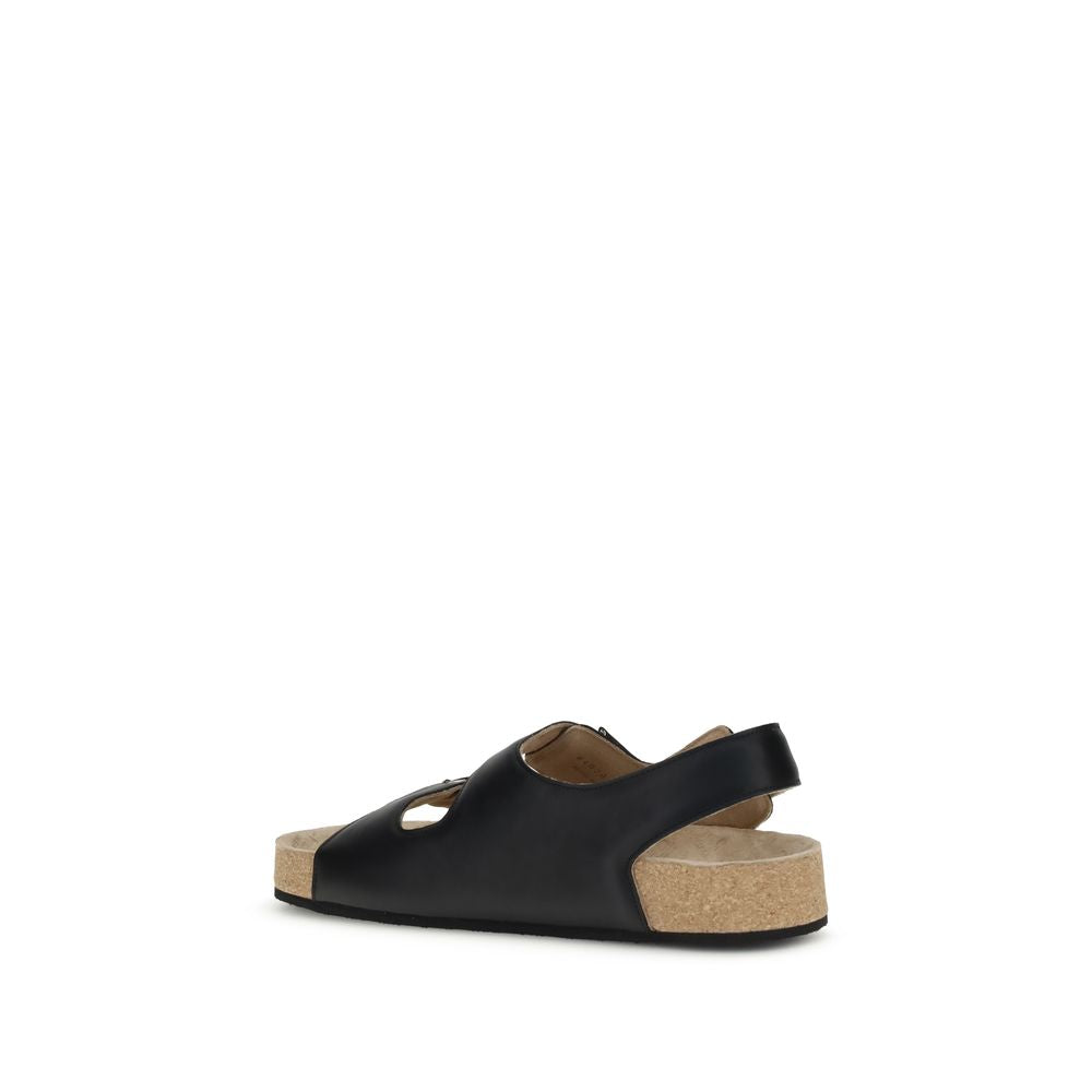 Black Calf Leather Bos Taurus Flat SandalsBalenciaga’s Scholl Flat Sandals, made of calfskin leather, are the result of a collaboration between the two brands and blend comfort and contemporary style. They feature three adjustable straps with metal buckle