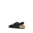 Black Calf Leather Bos Taurus Flat SandalsBalenciaga’s Scholl Flat Sandals, made of calfskin leather, are the result of a collaboration between the two brands and blend comfort and contemporary style. They feature three adjustable straps with metal buckle