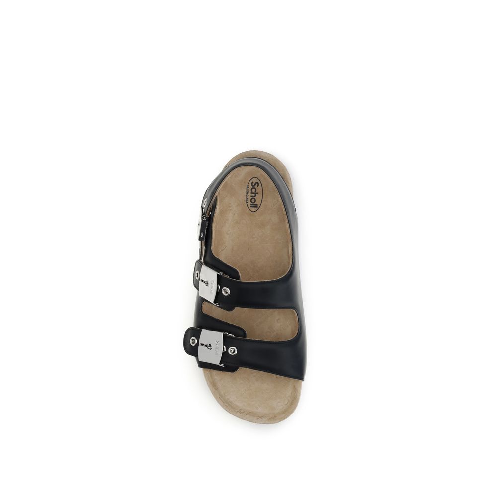 Black Calf Leather Bos Taurus Flat SandalsBalenciaga’s Scholl Flat Sandals, made of calfskin leather, are the result of a collaboration between the two brands and blend comfort and contemporary style. They feature three adjustable straps with metal buckle