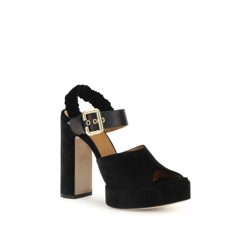 Black Calf Leather Bos Taurus Platform PumpsChloé’s Aria Pumps combine retro elegance and distinctive details. Made of velvety, vegetable-tanned calfskin, they feature a block heel with platform and a wavy sole with an original design. The ruched back str
