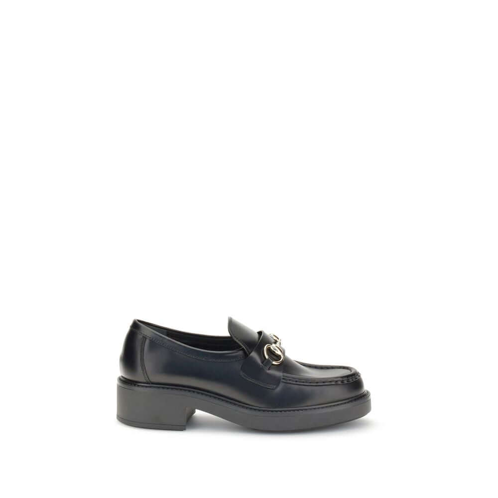Black Calf Leather Bos Taurus Slip-On LoafersGucci’s Horsebit Loafers are a timeless classic reimagined with a contemporary edge. Featuring a round toe and a sturdy block heel, they feature the House’s iconic metal horsebit detail on the front. A versatil