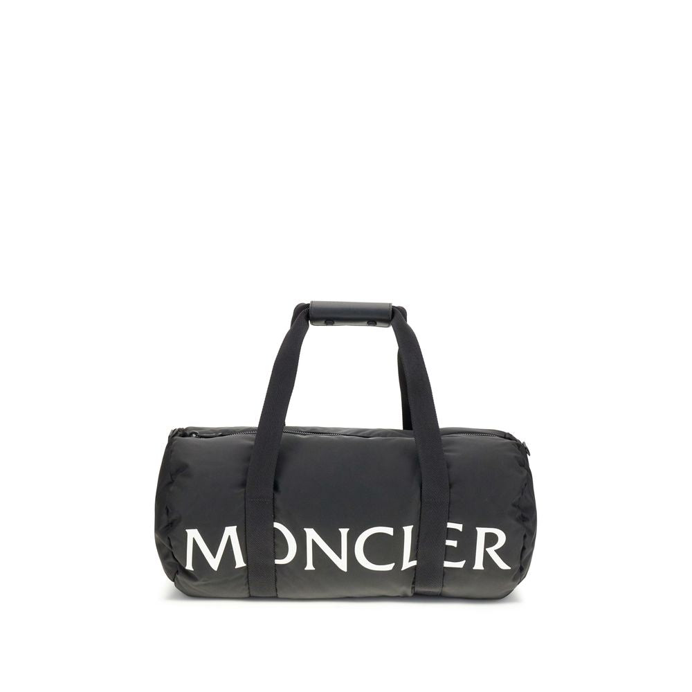 Black Nylon Luggage And TravelThe Moncler duffle Travel Bag combines functionality and style in a sporty, elegant design. Crafted from nylon with DIST-certified down padding, it features leather-tab handles with snap buttons, as well as an adjustable and