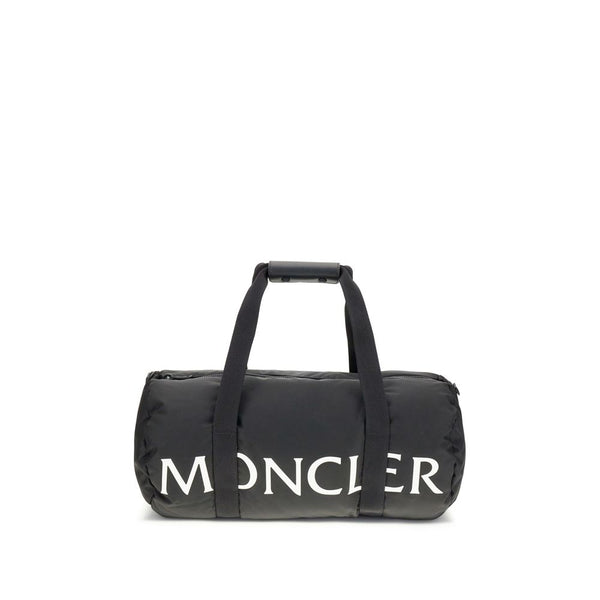 Black Nylon Luggage And TravelThe Moncler duffle Travel Bag combines functionality and style in a sporty, elegant design. Crafted from nylon with DIST-certified down padding, it features leather-tab handles with snap buttons, as well as an adjustable and