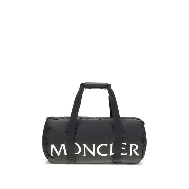 Black Nylon Luggage And TravelThe Moncler duffle Travel Bag combines functionality and style in a sporty, elegant design. Crafted from nylon with DIST-certified down padding, it features leather-tab handles with snap buttons, as well as an adjustable and