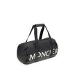 Black Nylon Luggage And TravelThe Moncler duffle Travel Bag combines functionality and style in a sporty, elegant design. Crafted from nylon with DIST-certified down padding, it features leather-tab handles with snap buttons, as well as an adjustable and