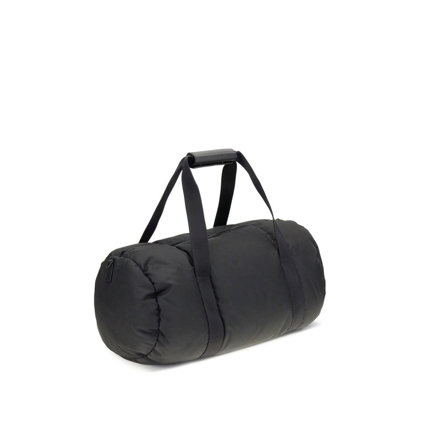 Black Nylon Luggage And TravelThe Moncler duffle Travel Bag combines functionality and style in a sporty, elegant design. Crafted from nylon with DIST-certified down padding, it features leather-tab handles with snap buttons, as well as an adjustable and